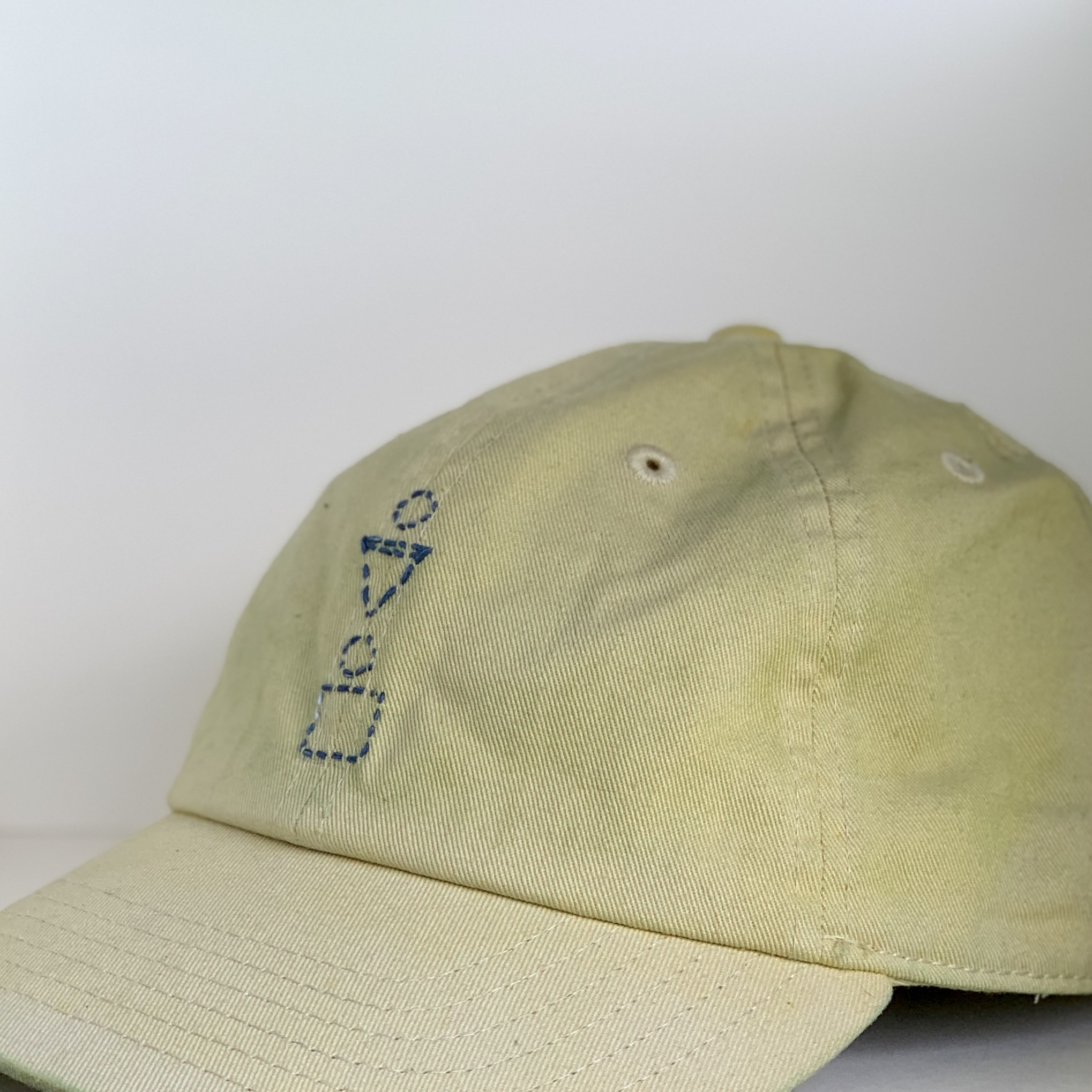 yellow weld dyed hat with indigo thread